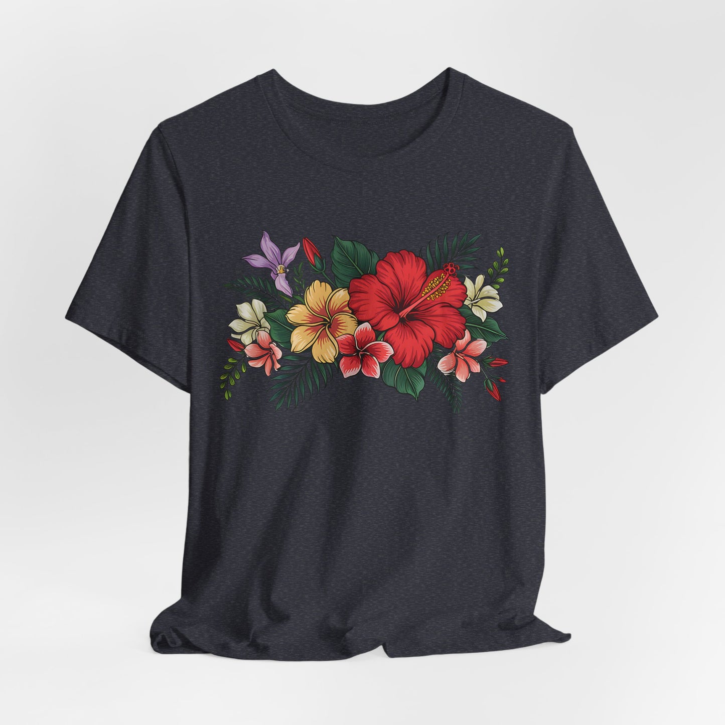 The Tropical Floral Unisex T-Shirt - Vibrant Summer Style features a dark base with a vivid floral print of red, yellow, and white hibiscus flowers and green leaves on soft Airlume cotton.