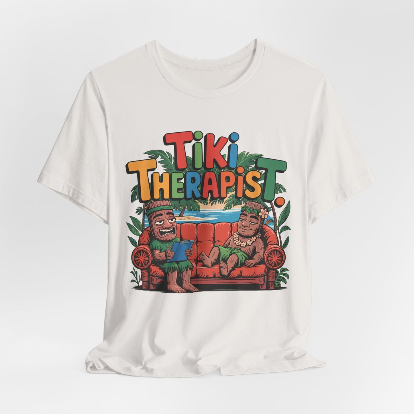 The Tiki Therapist Unisex Tiki T-Shirt is a breathable cotton tee with a playful Tiki Therapist print and vibrant tiki figures on a red couch under green leaves—perfect for beach lovers seeking fun Hawaiian style.