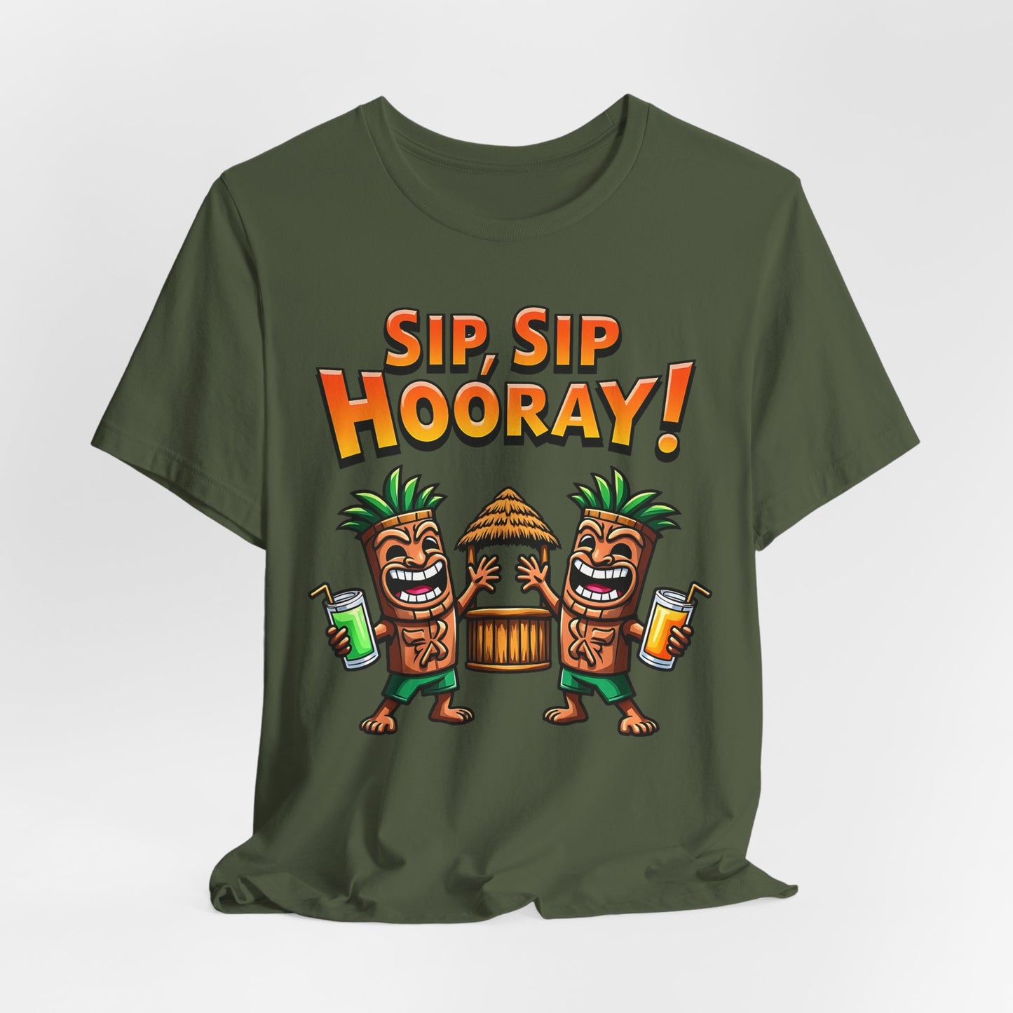 The Sip Sip Hooray Tropical Unisex Tiki T-Shirt in olive green features two cartoon tiki figures with drinks, a tiki hut between them, bold orange SIP, SIP HOORAY! text above, and is made from soft Airlume cotton.