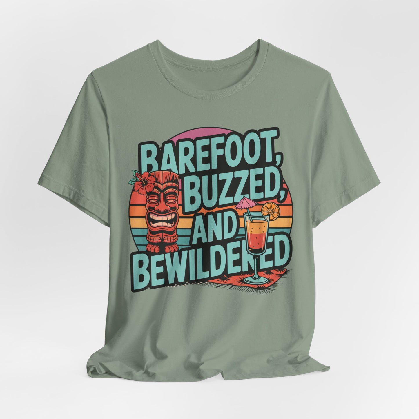 The Tropical Vibes Tiki T-Shirt – Barefoot, Buzzed, and Bewildered showcases a vibrant tiki face, tropical cocktail, and bold text on a green unisex tee with a striped sunset—ideal for summer celebrations.