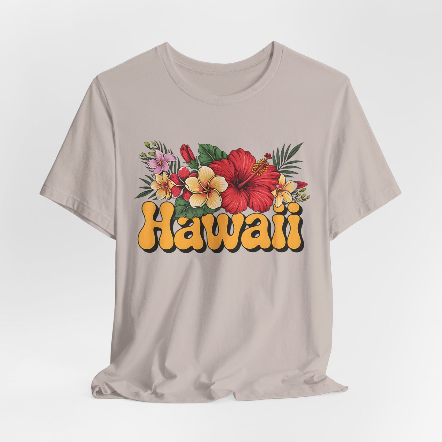 The Hawaiian Floral Unisex Tee – Beach Vibes and Island Spirit features colorful tropical flowers and green leaves above Hawaii in bold, yellow-orange retro lettering on soft beige Airlume cotton.