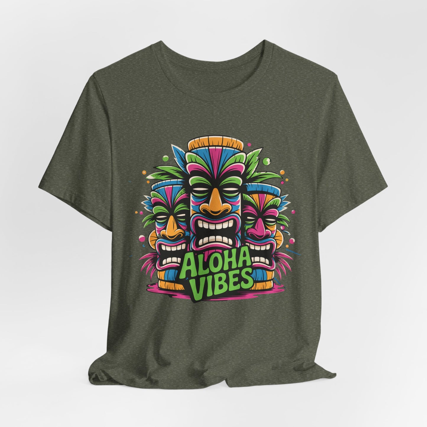 The Aloha Vibes Unisex Short Sleeve Tiki T-Shirt features three colorful tiki masks above “Aloha Vibes” text in bold style—perfect as a tropical beach or summer festival shirt for any fan of vibrant island vibes.