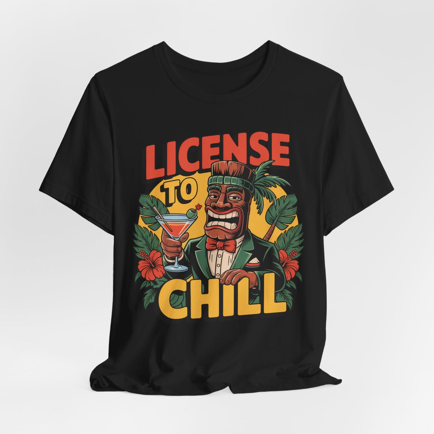 The T-Shirt - License to Chill Tropical Graphic Tiki T-Shirt features a cartoon tiki in a suit with a cocktail, tropical leaves, red flowers, and bold LICENSE TO CHILL text—an ideal playful gift for summer barbecues.