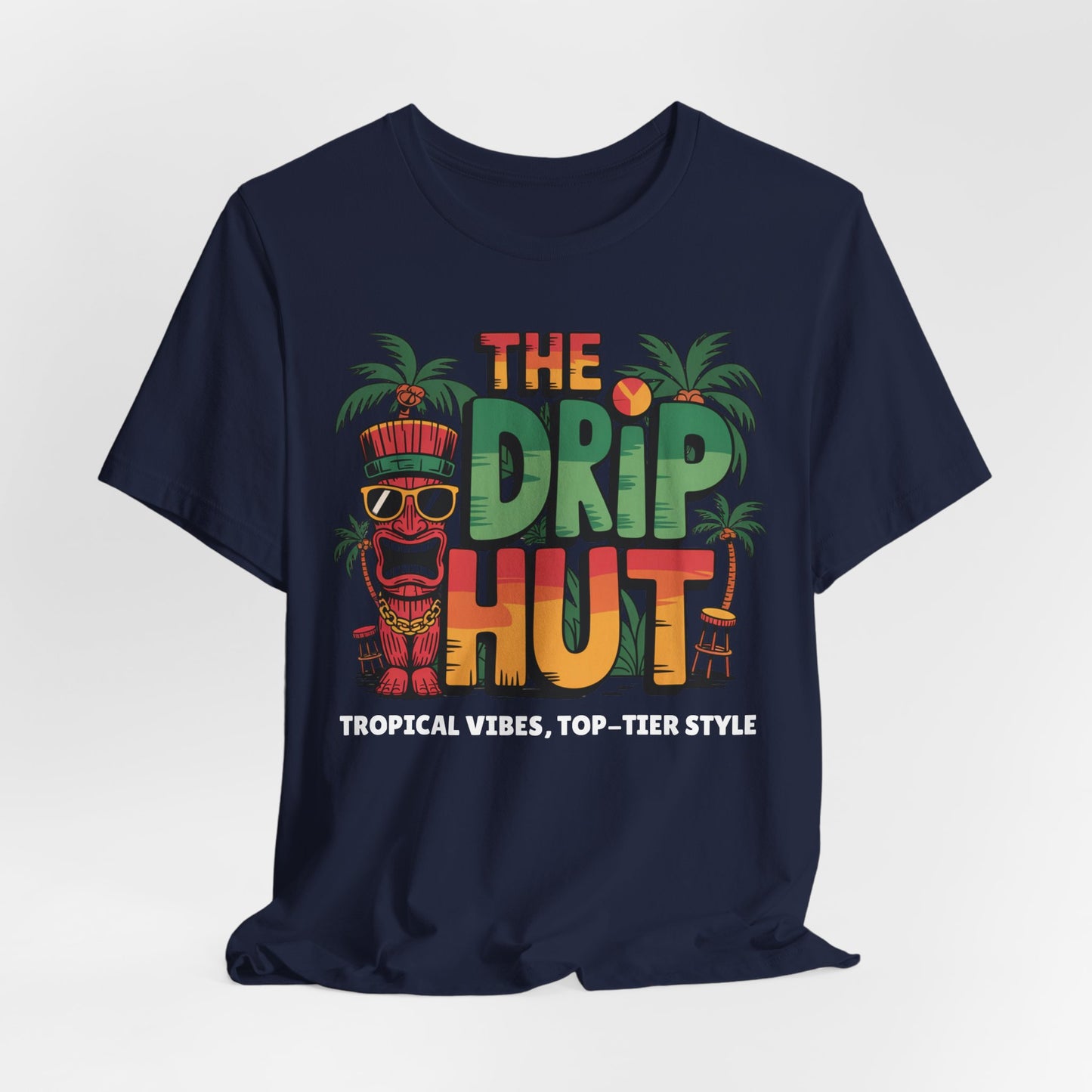 The Tropical Vibes Unisex Tiki T-Shirt - The Drip Hut features a colorful tiki face, palm trees, and THE DRIP HUT text, with Tropical Vibes, Top-Tier Style in white print—perfect for showcasing ultimate island vibes.