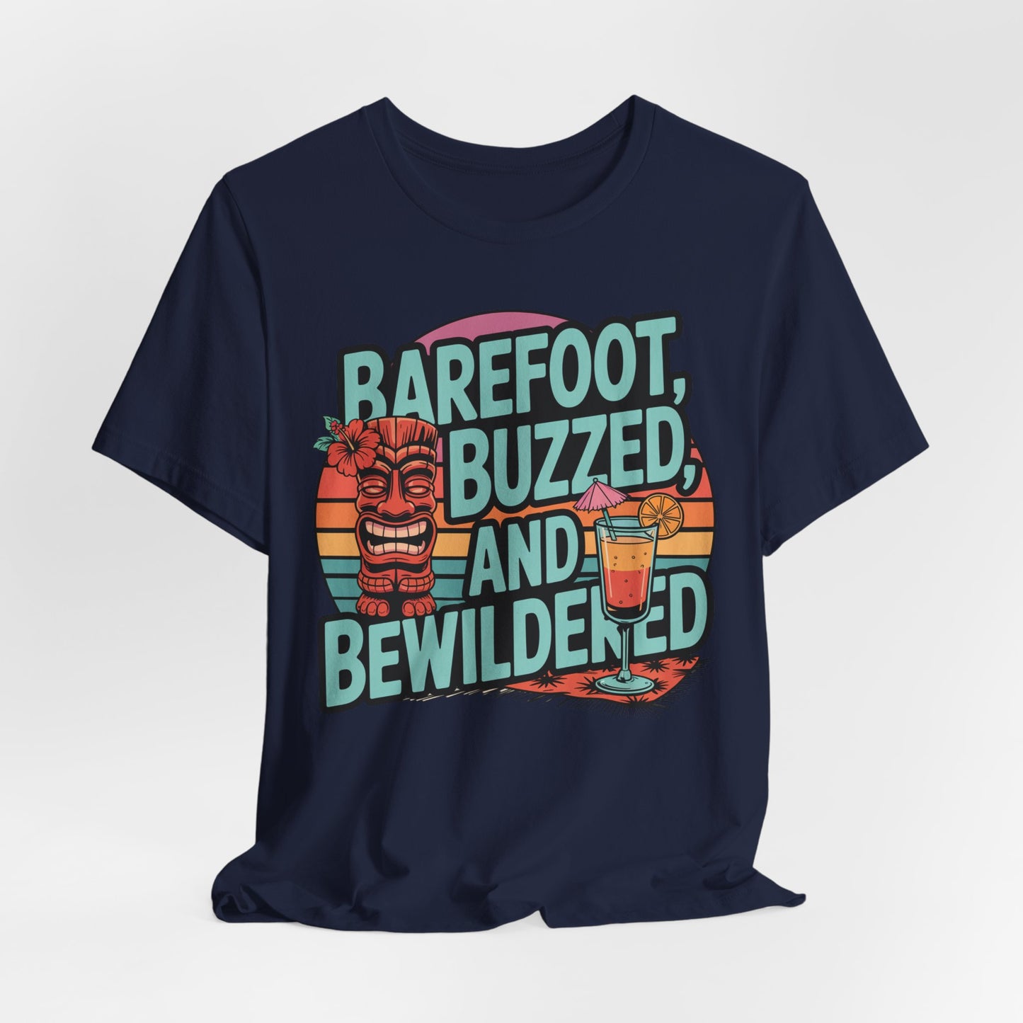 The Tropical Vibes Tiki T-Shirt - Barefoot, Buzzed, and Bewildered is a unisex navy tee with colorful text, a grinning tiki figure, tropical drink, and retro sunset stripes—ideal for summer parties.
