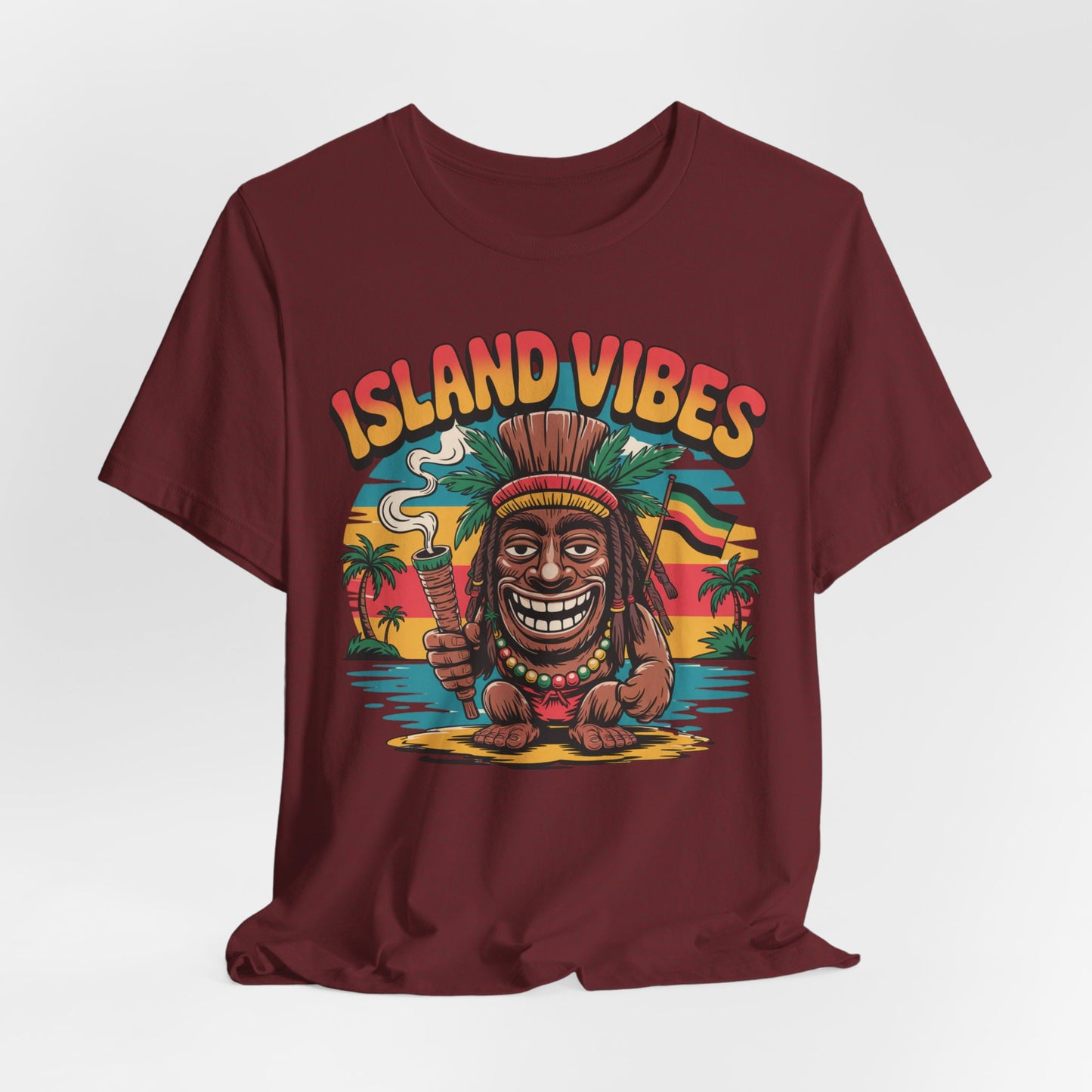Perfect for vacations and summer fun, the Island Vibes Unisex Jersey Tiki T-Shirt features a maroon design with a smiling tiki holding a joint and spear, Island Vibes text, palm trees, and a vibrant sunset backdrop.