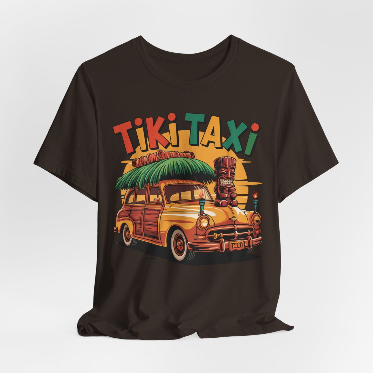 The Tiki Taxi Graphic Tiki T-Shirt for Summer Vibes is a black unisex jersey featuring a vibrant yellow vintage car, surfboards, tiki statue, palm trees, and bold “Tiki Taxi” text—ideal for anyone who loves the beach or tropical style.