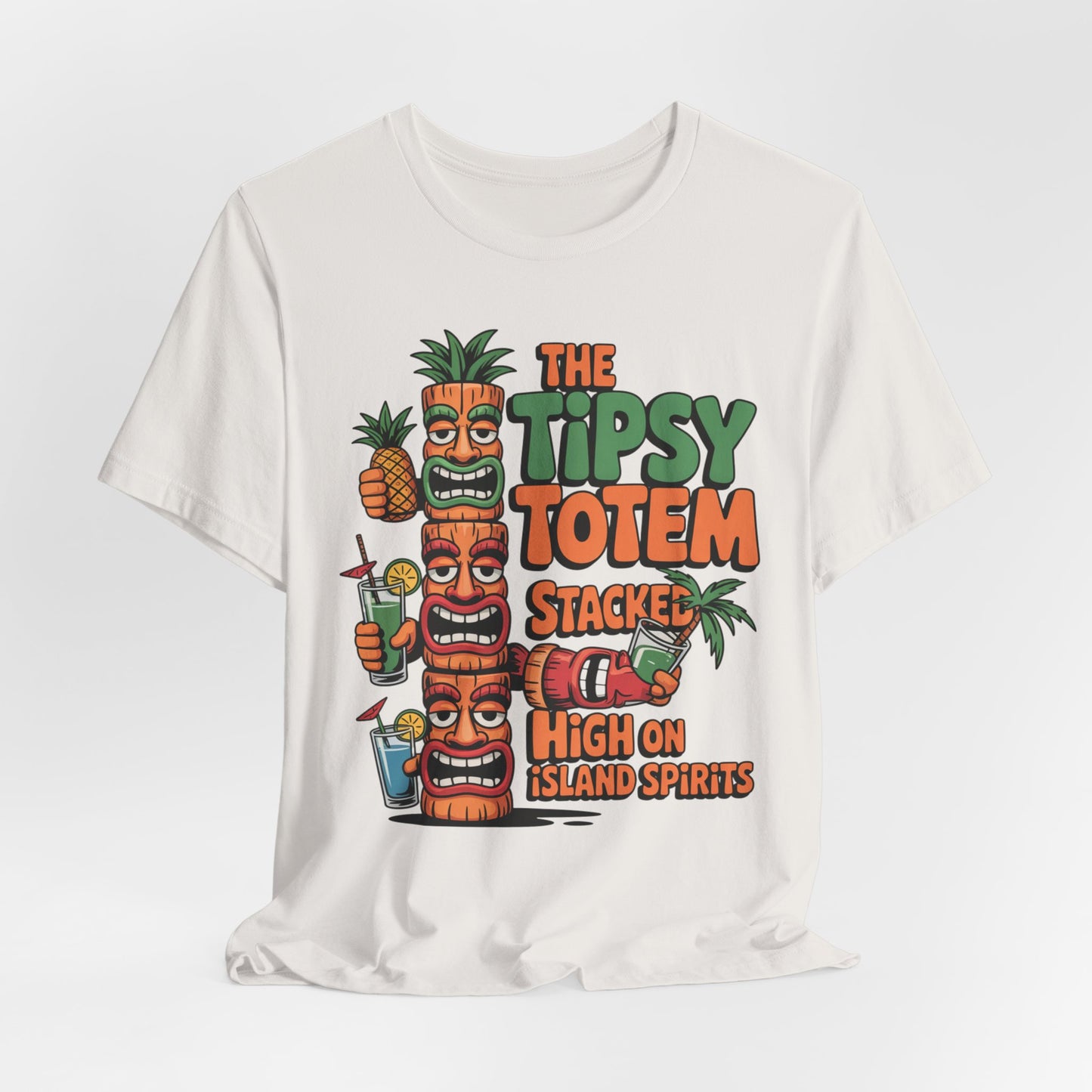 The Tiki Cocktail Tee - The Tipsy Totem Graphic Shirt features cartoon tiki totems, tropical drinks, and pineapples with colorful text—perfect for summer parties and a vibrant island vibe.