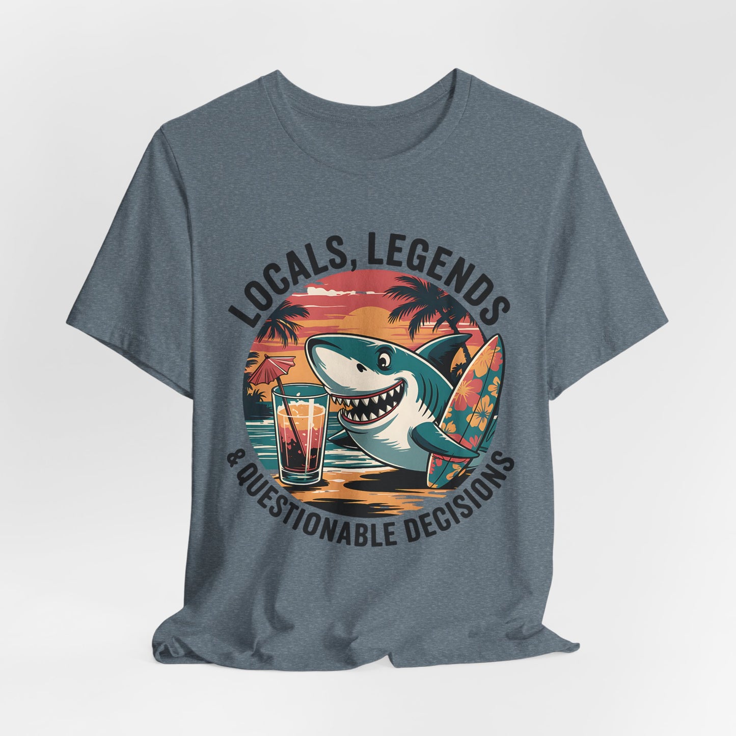 The Funny Shark Graphic T-Shirt - Locals, Legends & Questionable Decisions is a gray unisex tee with a vibrant shark and surfboard by a sunset, plus the playful text: Locals, Legends & Questionable Decisions—perfect for beach fans.