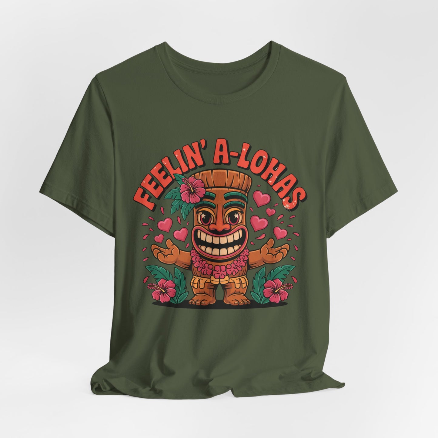 The Feelin A-Lohas Unisex Jersey Tiki T-Shirt features a cheerful tiki with pink hearts and hibiscus flowers, plus bold red FEELIN A-LOHAS text. This fun tropical graphic shirt adds a playful island vibe to your casual style.