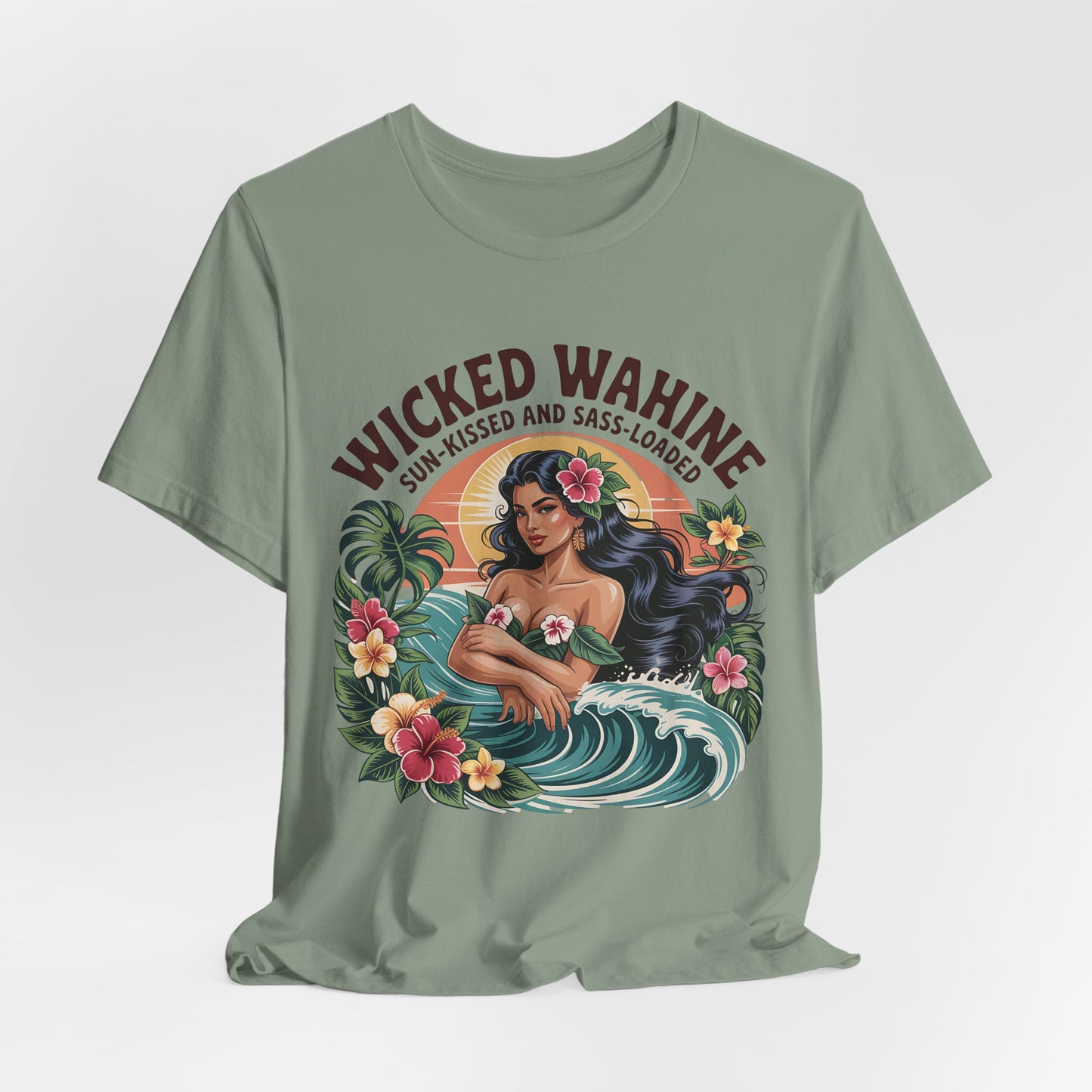 The Wicked Wahine Graphic T-Shirt - Sun-Kissed and Sass-Laden Unisex Jersey Shirt in sage green features a long-haired woman, hibiscus flowers, and ocean waves with Wicked Wahine above and Sun-Kissed and Sass-Loaded below. Tropical details complete the look.