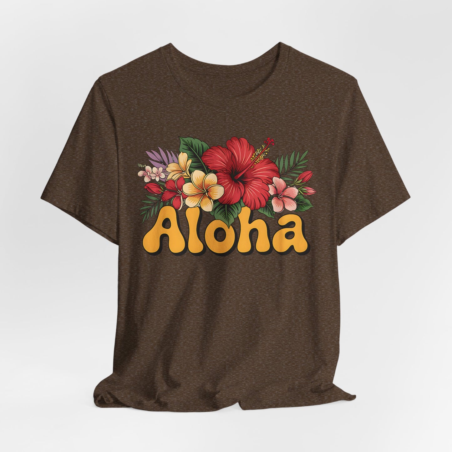 The Aloha Floral Unisex Jersey T-Shirt features a bold yellow Aloha design with vibrant hibiscus and plumeria on soft Airlume cotton, perfect for tropical vibes and casual summer style.