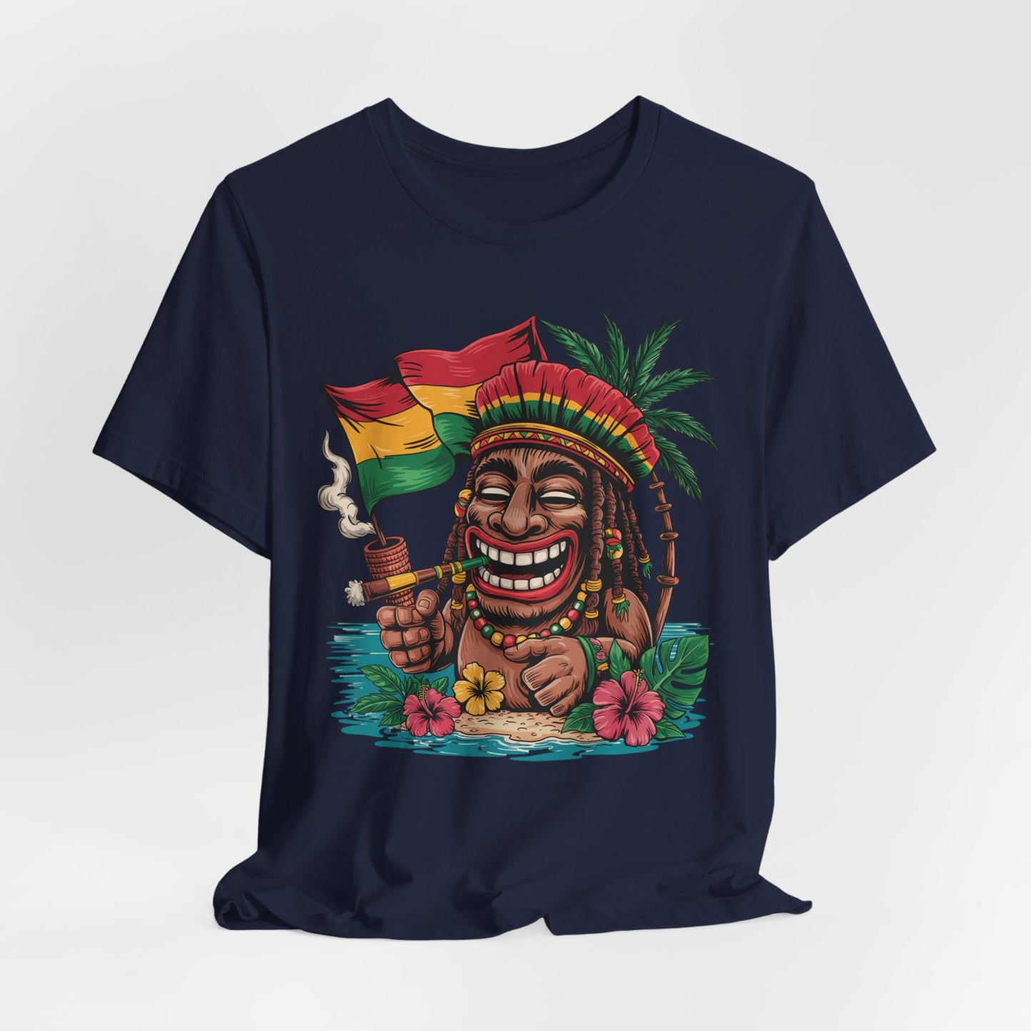 The Tropical Vibes Unisex Jersey Tiki T-Shirt features playful island art: a cartoon figure with dreadlocks, red-green hat, pipe, and Rasta flag, surrounded by flowers and palm trees for fun tropical flair.