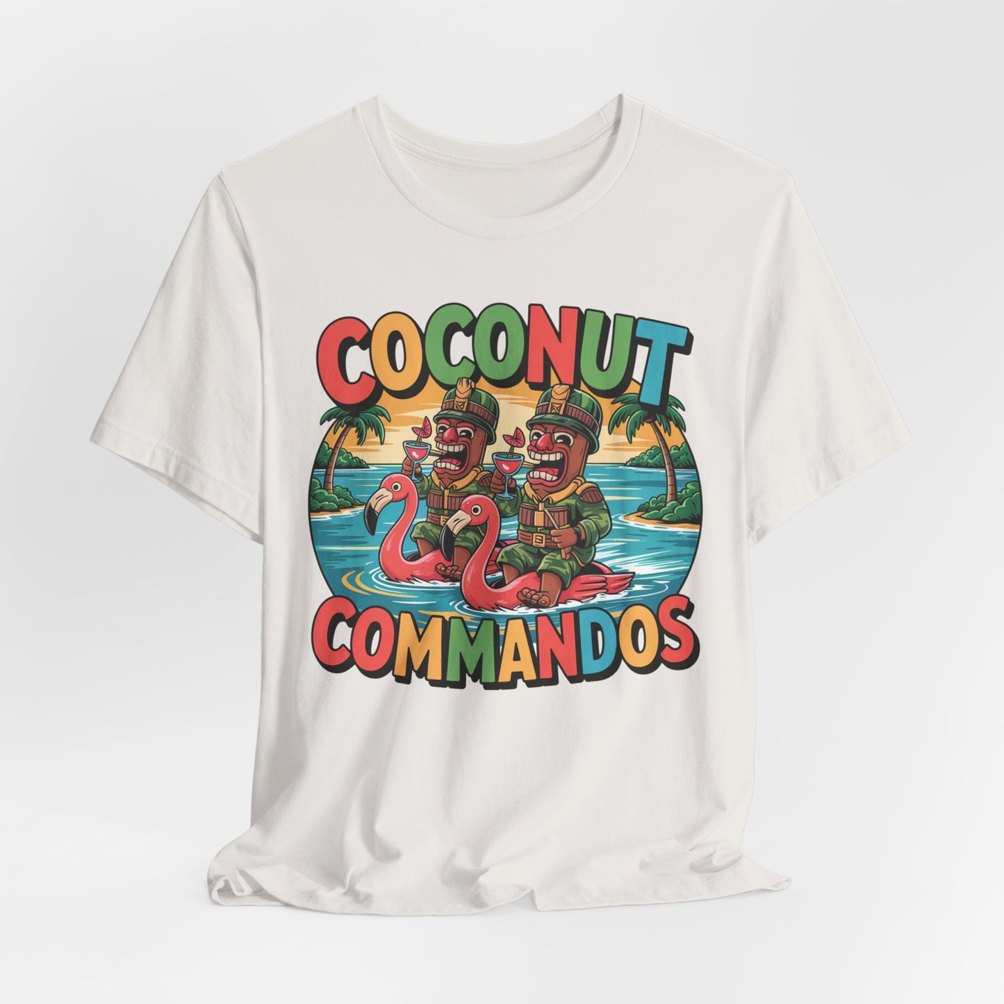 The Coconut Commandos Graphic Tiki T-Shirt features two cartoon commandos in army gear on inflatable flamingos with palm trees and “COCONUT COMMANDOS” text—a fun summer vibe perfect for beach lovers.