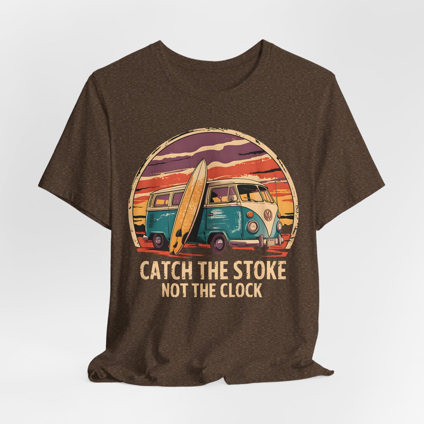 The Catch the Stoke Surf Tee - Unisex Jersey Short Sleeve T-Shirt features a brown, breathable cotton design with a retro van, surfboard, and sunset. The text “CATCH THE STOKE NOT THE CLOCK.” is below the image for classic surf vibes.