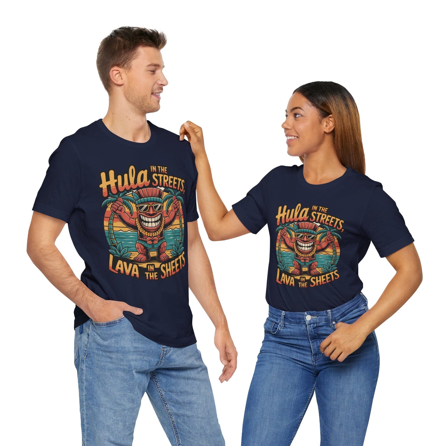 A smiling couple wears the Hula in the Streets Short Sleeve Tiki T-Shirt—Fun Tropical T-Shirt for Summer Celebrations—showing off its playful vibe, perfect for festivals. The woman touches his shoulder warmly as they pose together.