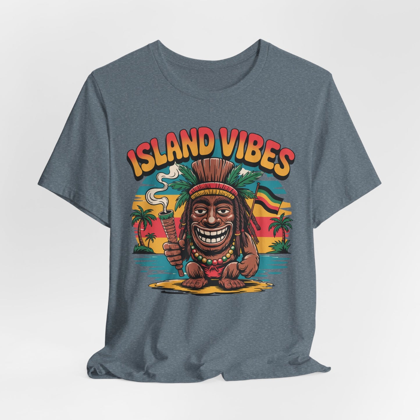 The Island Vibes Unisex Jersey Tiki T-Shirt features a cartoon tiki statue flashing a peace sign and smoking, set against a sunset with palm trees and ocean, plus bold orange “ISLAND VIBES” text—perfect for vacation and summer fun.