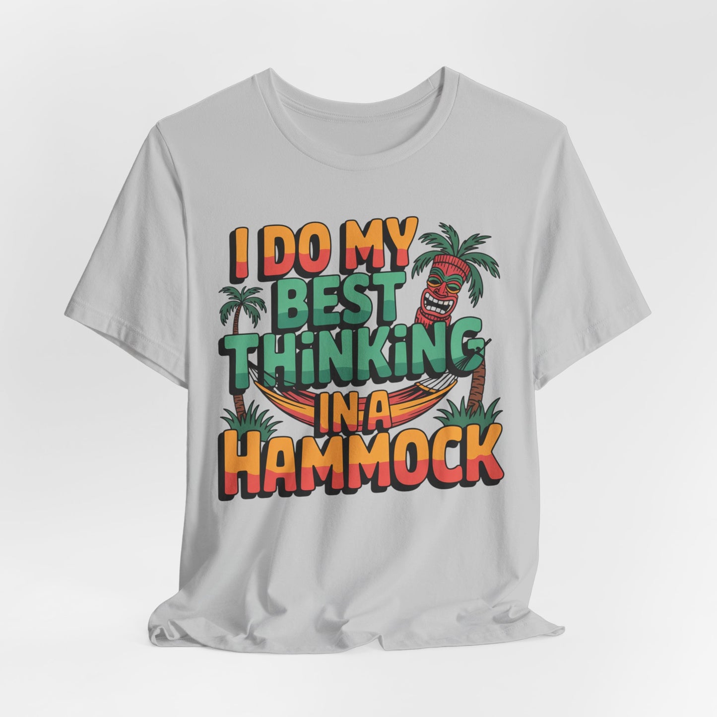The I Do My Best Thinking in a Hammock Unisex Tiki T-Shirt – Relaxed Summer Vibes Shirt features colorful text, a smiling tiki, and palm trees on soft gray Airlume cotton for an easygoing look.
