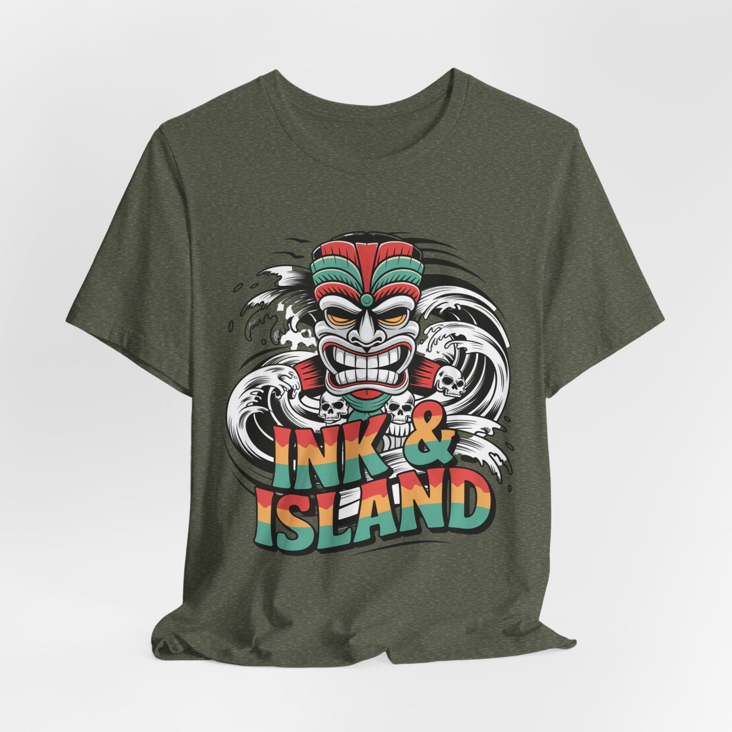The Tropical Ink & Island Unisex Tiki T-Shirt features a fierce tiki mask with ocean waves and bold red, orange, and teal INK & ISLAND text—ideal for island culture lovers seeking unique summer vibes and stylish beachwear.