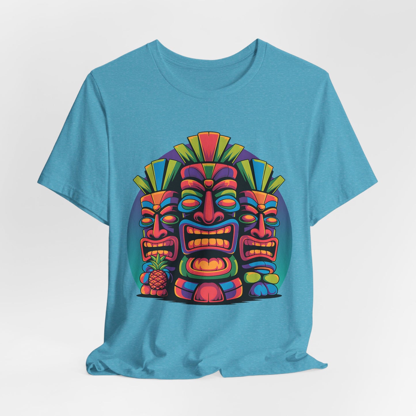 The Vibrant Tribal Mask Tiki T-Shirt - Unisex Short Sleeve features three stylized tiki masks and a small pineapple on a blue tee, adding bold geometric flair to any casual wardrobe.