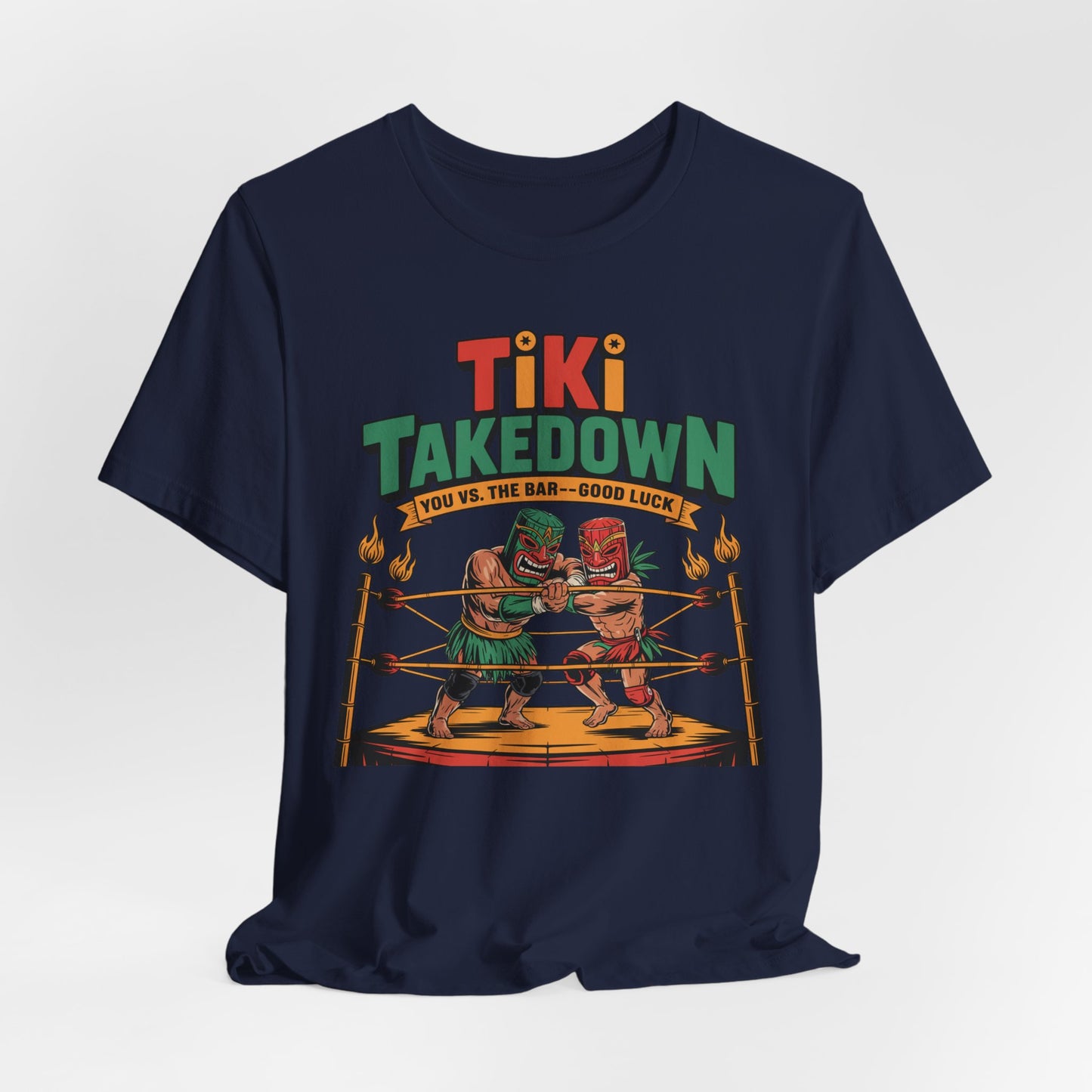The Tiki Takedown Unisex Jersey Tiki T-Shirt features two tiki figures boxing in a ring with torches and colorful Tiki Takedown text. Made from soft Airlume cotton, this fun graphic tee is perfect for bar lovers—good luck taking on the bar!.