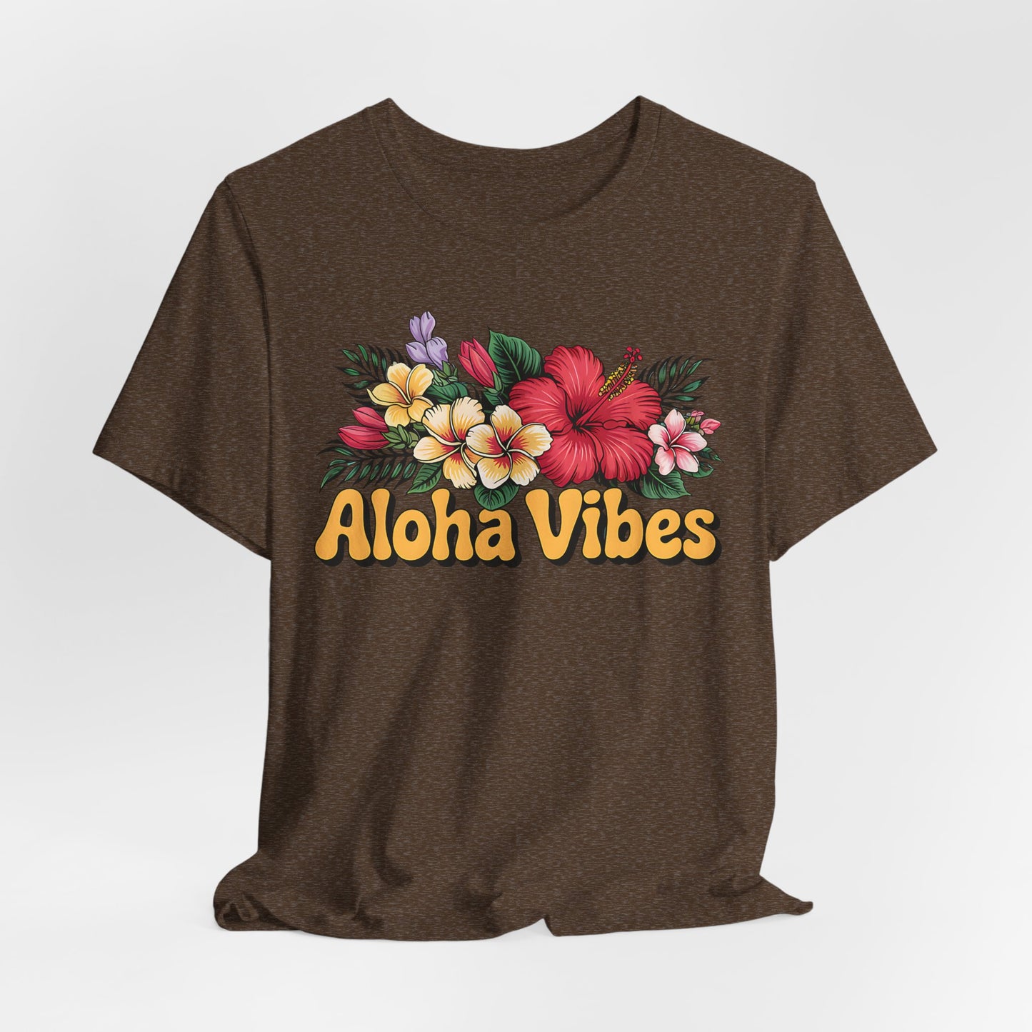 The Aloha Vibes Floral Unisex T-Shirt for Island Vibes showcases vibrant tropical flowers and green leaves above bold yellow “Aloha Vibes” text, made from breathable fabric for all-day comfort.
