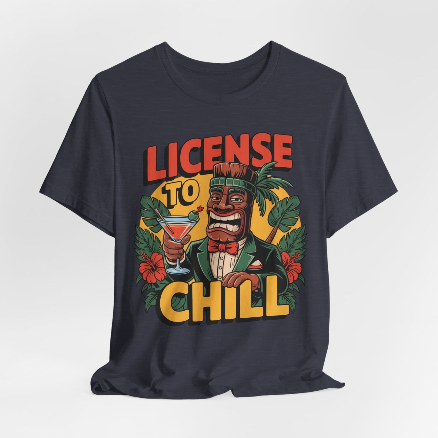 The T-Shirt - License to Chill Tropical Graphic Tiki T-Shirt is a black unisex tee with a vibrant tiki in a suit, cocktail in hand, tropical designs, and bold LICENSE TO CHILL text—a playful gift for summer barbecues.