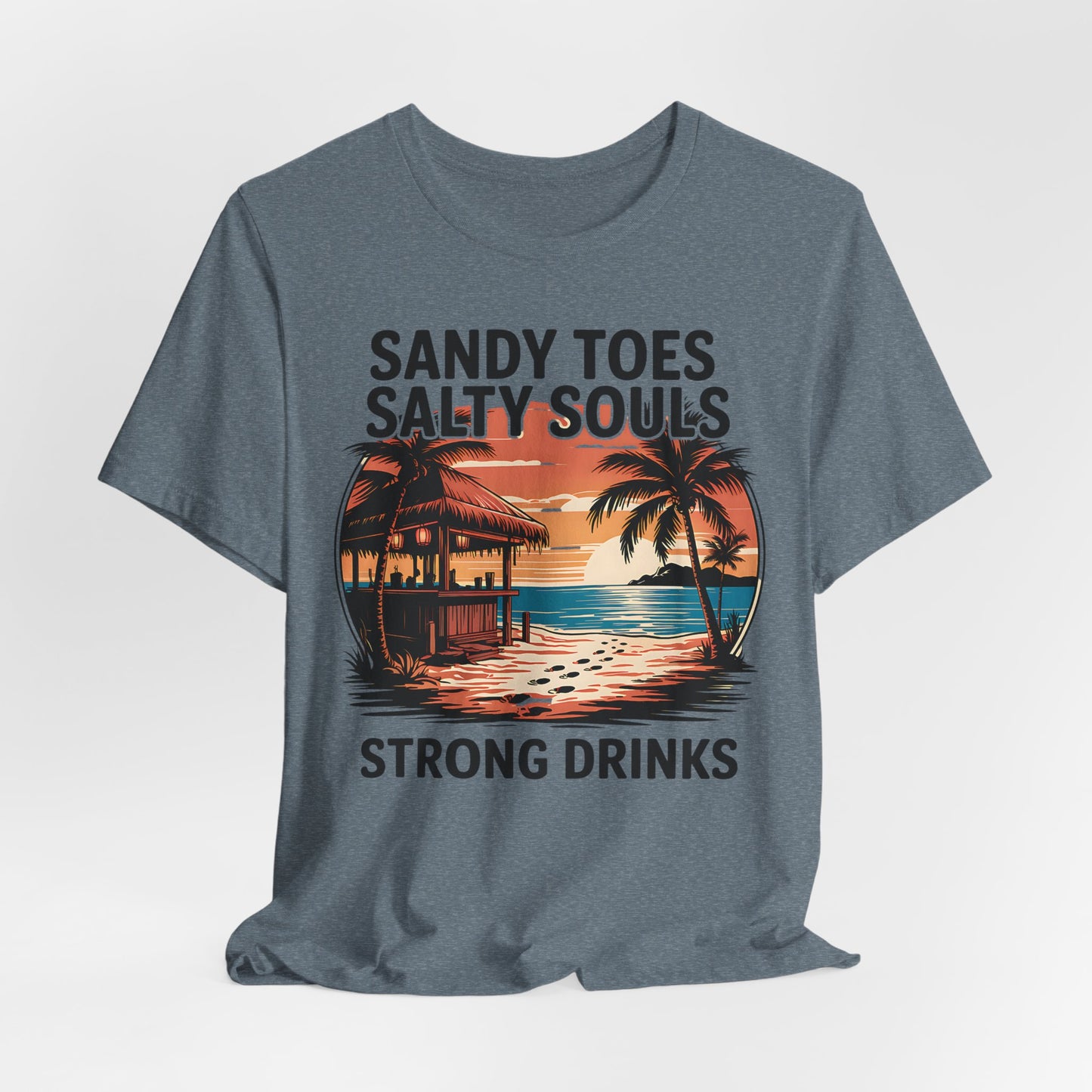 The Sandy Toes Salty Souls Tee - Unisex Jersey Short Sleeve for Beach Lovers features a tropical sunset with palm trees, hut, and ocean. Made from soft Airlume cotton. Reads: Sandy toes, salty souls, strong drinks.
