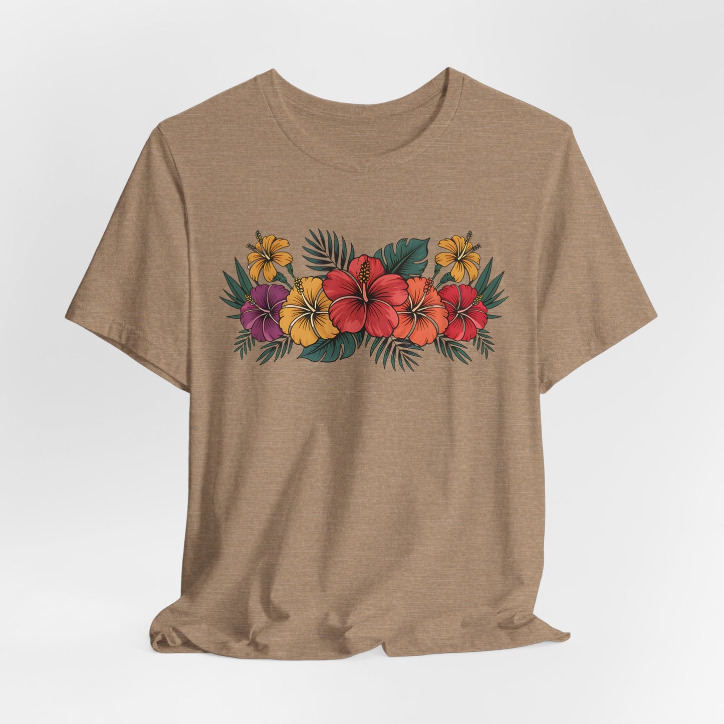 The Tropical Floral Unisex T-Shirt - Perfect for Summer Days features a vibrant print of red, yellow, and purple hibiscus flowers with green leaves on beige soft Airlume combed cotton for all-day comfort.