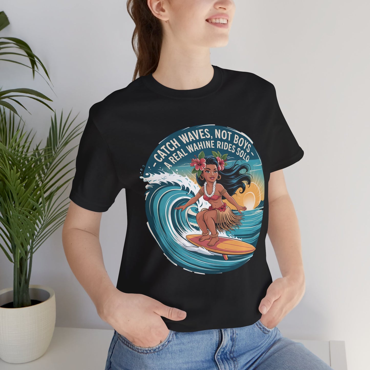 A smiling woman wears the Catch Waves Not Boys Wahine T-Shirt, featuring a surfing Hawaiian woman, tropical accents, and the text Catch Waves, Not Boys. A Real Wahine Rides Solo. Perfect for beach lovers.