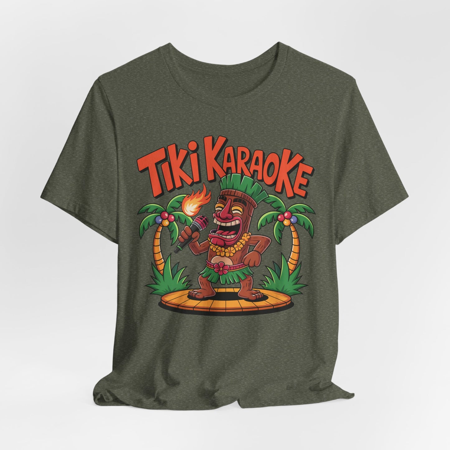 The Tiki Karaoke Unisex Short Sleeve Tiki T-Shirt features an olive-green color with a tiki figure and torch on a stage between palm trees, plus bold Tiki Karaoke text for a fun, tropical summer vibe.