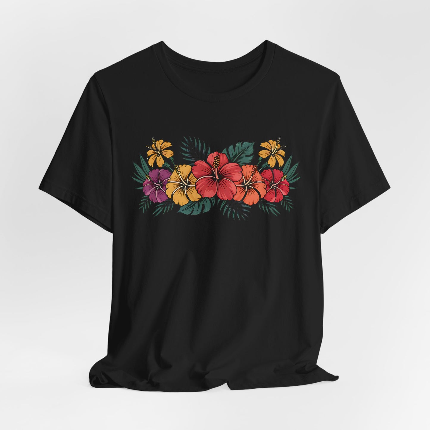 The Tropical Floral Unisex T-Shirt - Perfect for Summer Days features a vibrant floral print with red, yellow, and purple hibiscus flowers plus green leaves on soft black Airlume combed cotton.