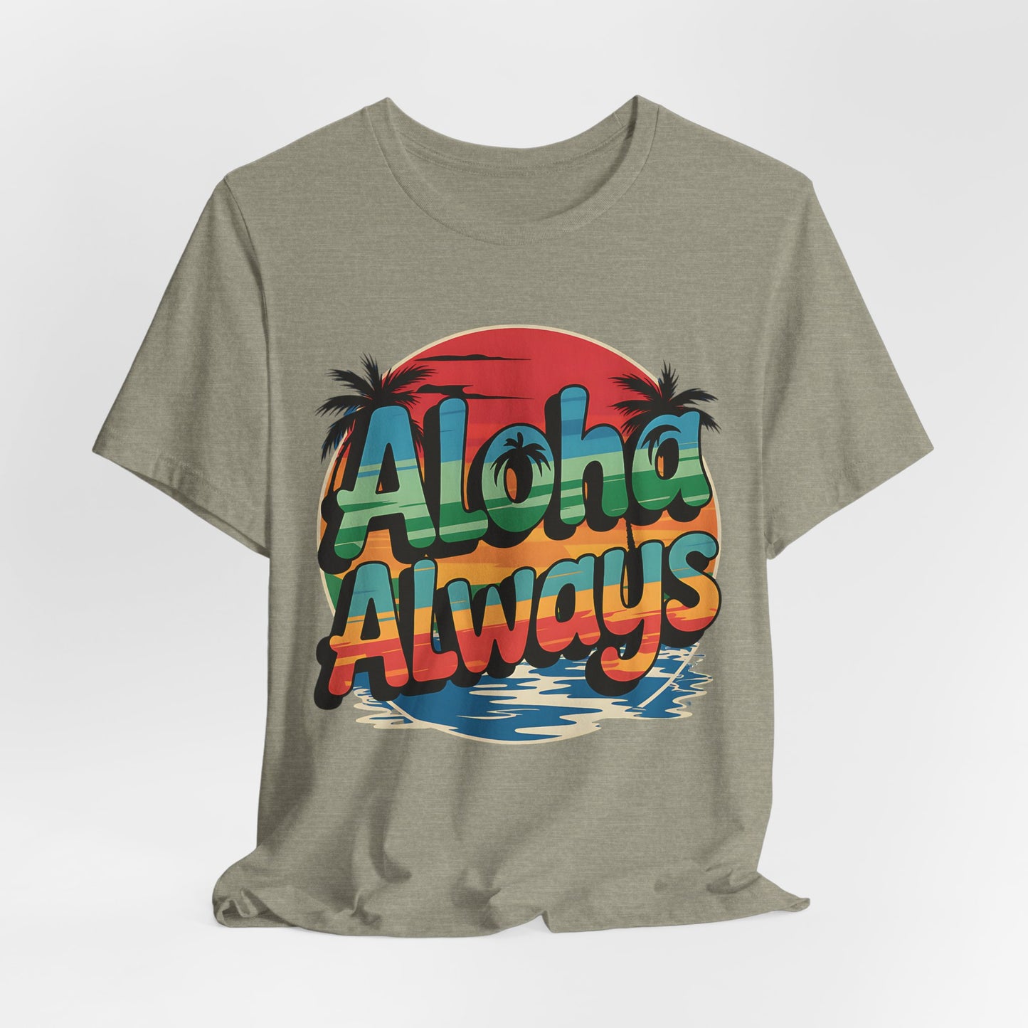 Graphic T-Shirt is a unisex short sleeve shirt in light olive with a retro “Aloha Always” text, featuring a vibrant sunset, palm trees, and water—ideal for beach lovers.