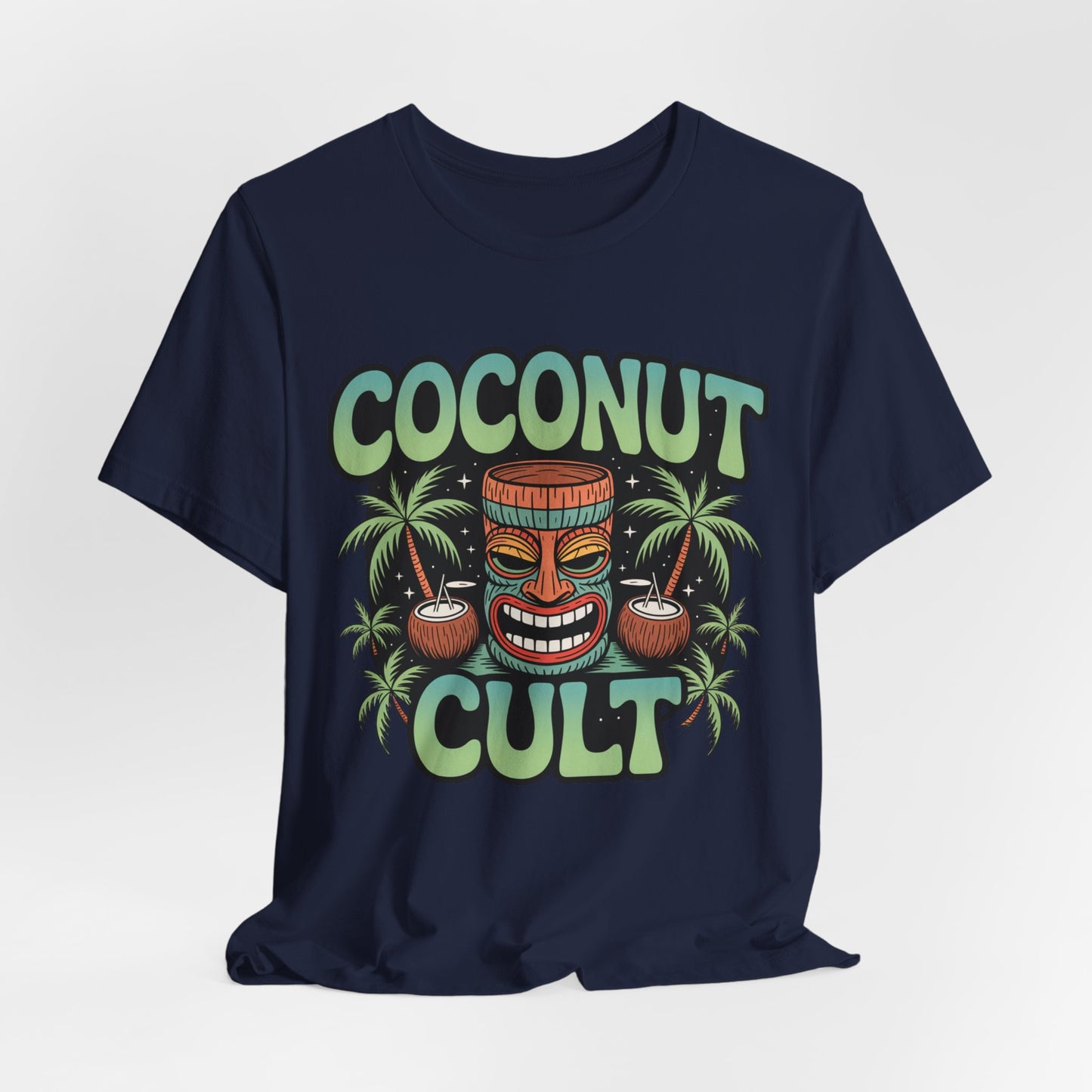 The Coconut Cult Unisex Jersey Tiki T-Shirt features a colorful tropical design with cartoon coco faces and palm trees. Made from soft Airlume Cotton, it’s perfect for beach lovers seeking comfort and fun vibes!.