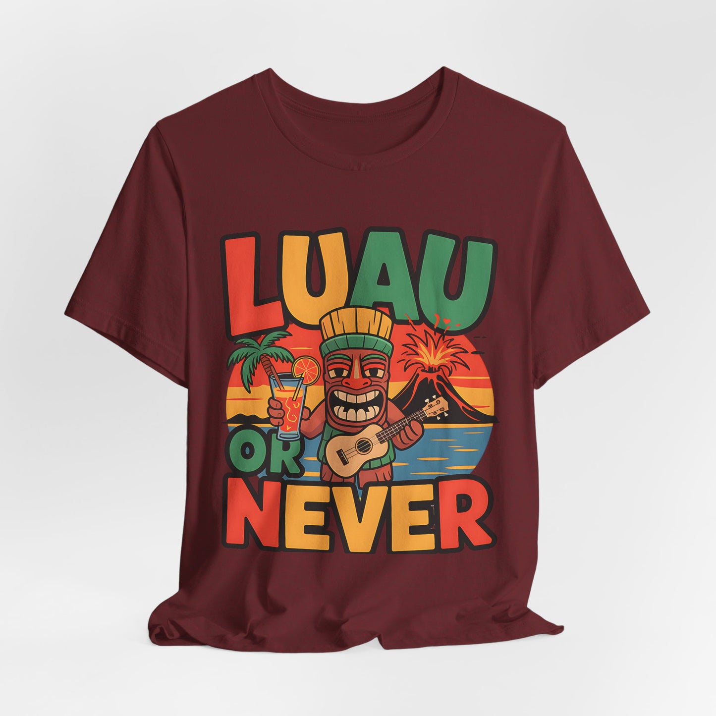 The Tropical Luau Short Sleeve Tiki T-Shirt features a vibrant maroon design with a tiki figure, palm trees, and LUAU OR NEVER text—perfect for embracing tropical vibes at summer celebrations.