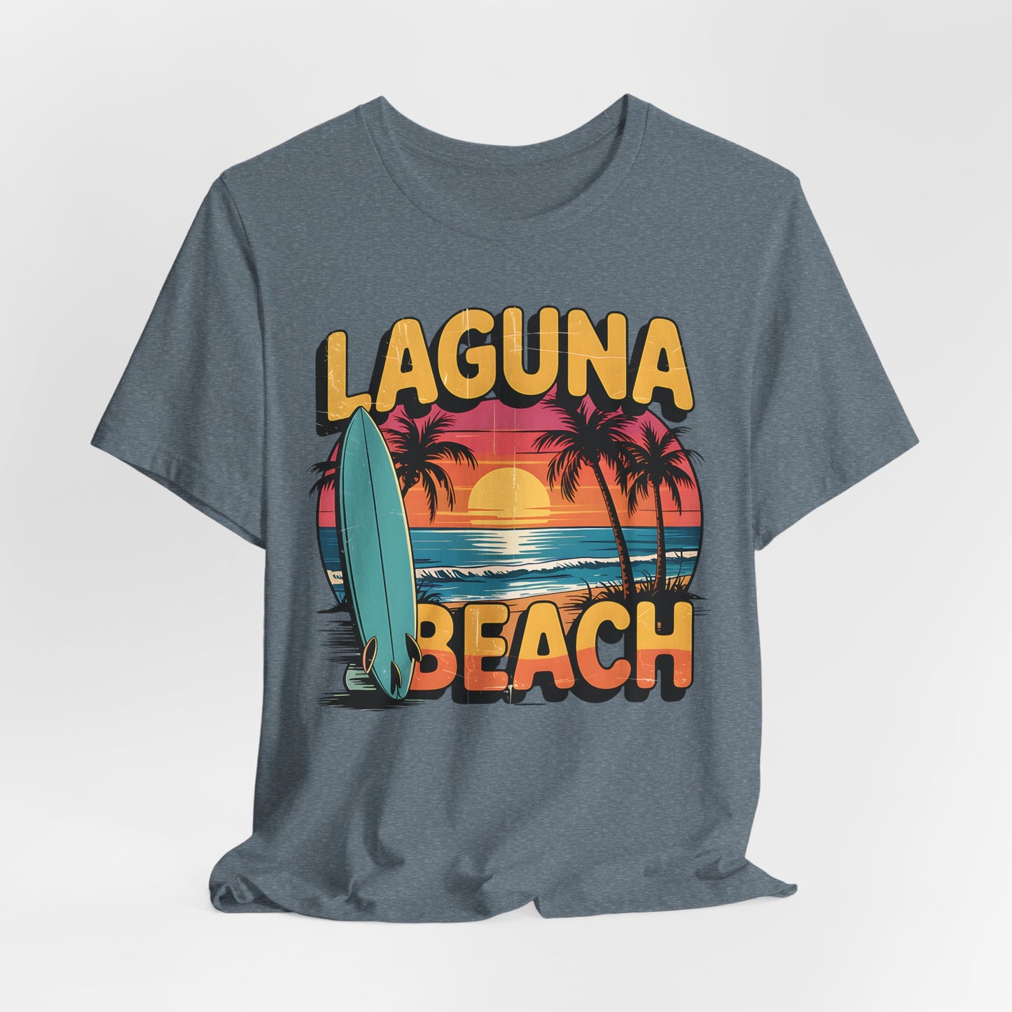 The Laguna Beach Sunset Surf Tee – Unisex Jersey Short Sleeve T-Shirt features a gray base, vibrant sunset, palm trees, surfboard graphic, bold yellow Laguna Beach text, and a relaxed fit for all-day comfort—perfect for beach adventures.