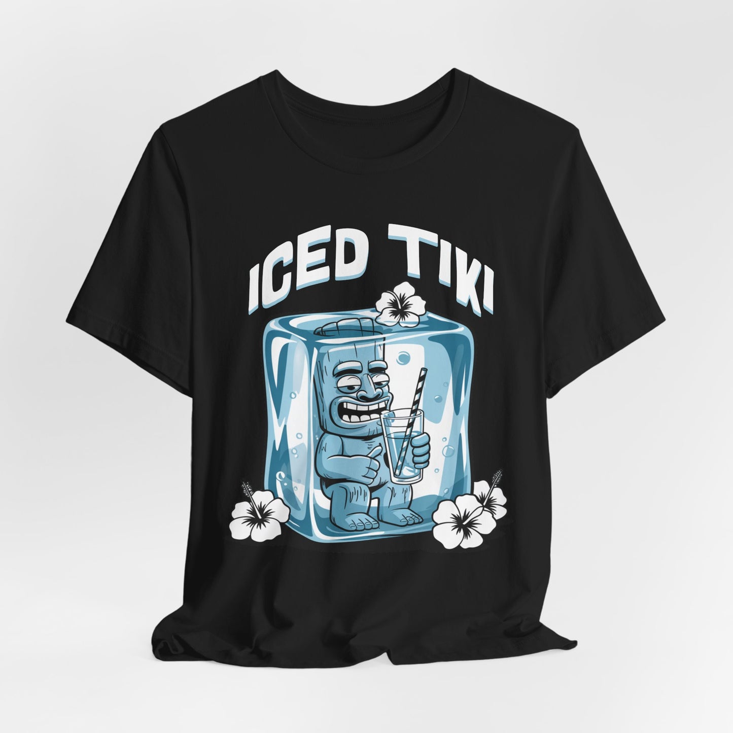 The Iced Tiki Unisex Jersey Tiki T-Shirt - Summer Vibes T-Shirt showcases a cartoon Tiki statue in an ice cube sipping from a straw, accented by white hibiscus flowers. Crafted from breathable, lightweight fabric for all-day comfort.