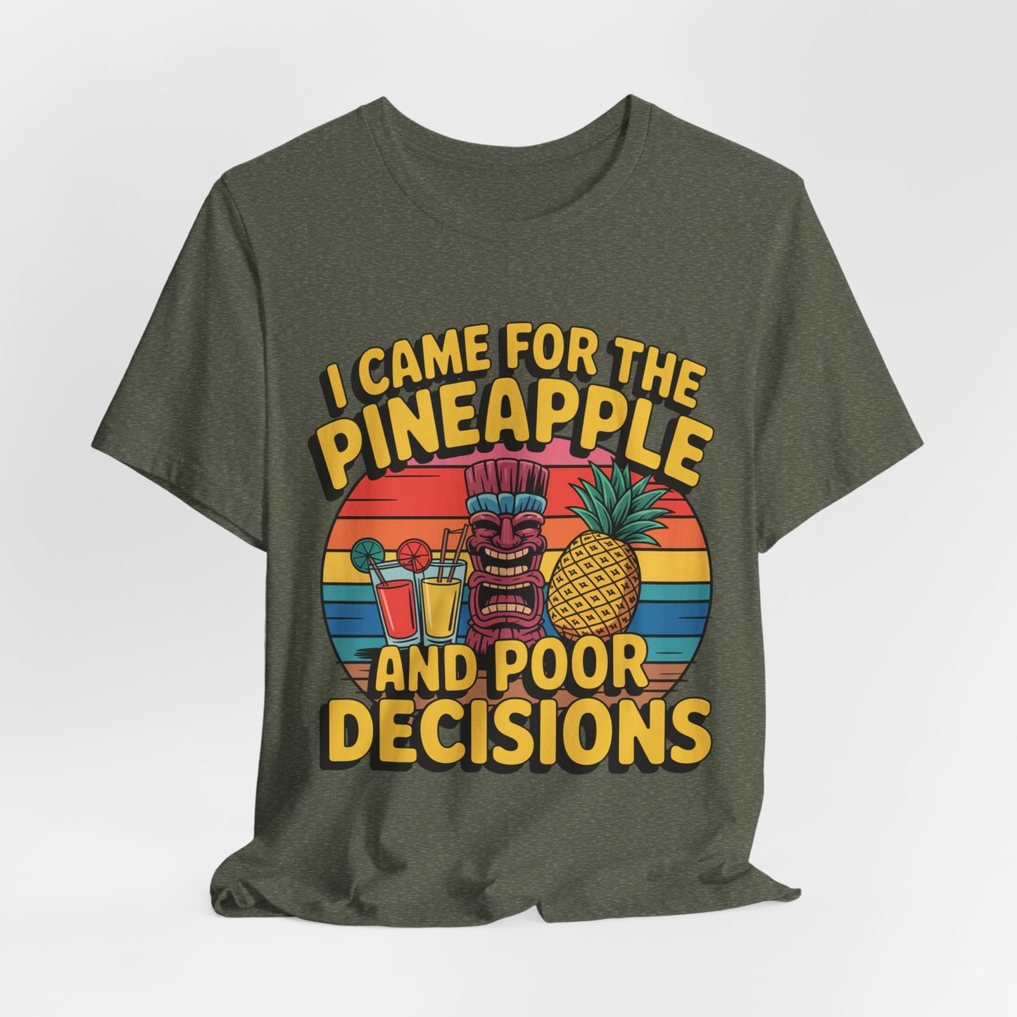 The Tropical Humor Tiki T-Shirt features a dark green color and a vibrant tiki mask, pineapple, cocktails, and sunset design. It reads, I Came for the Pineapple and Poor Decisions—perfect for summer fun or casual gatherings.