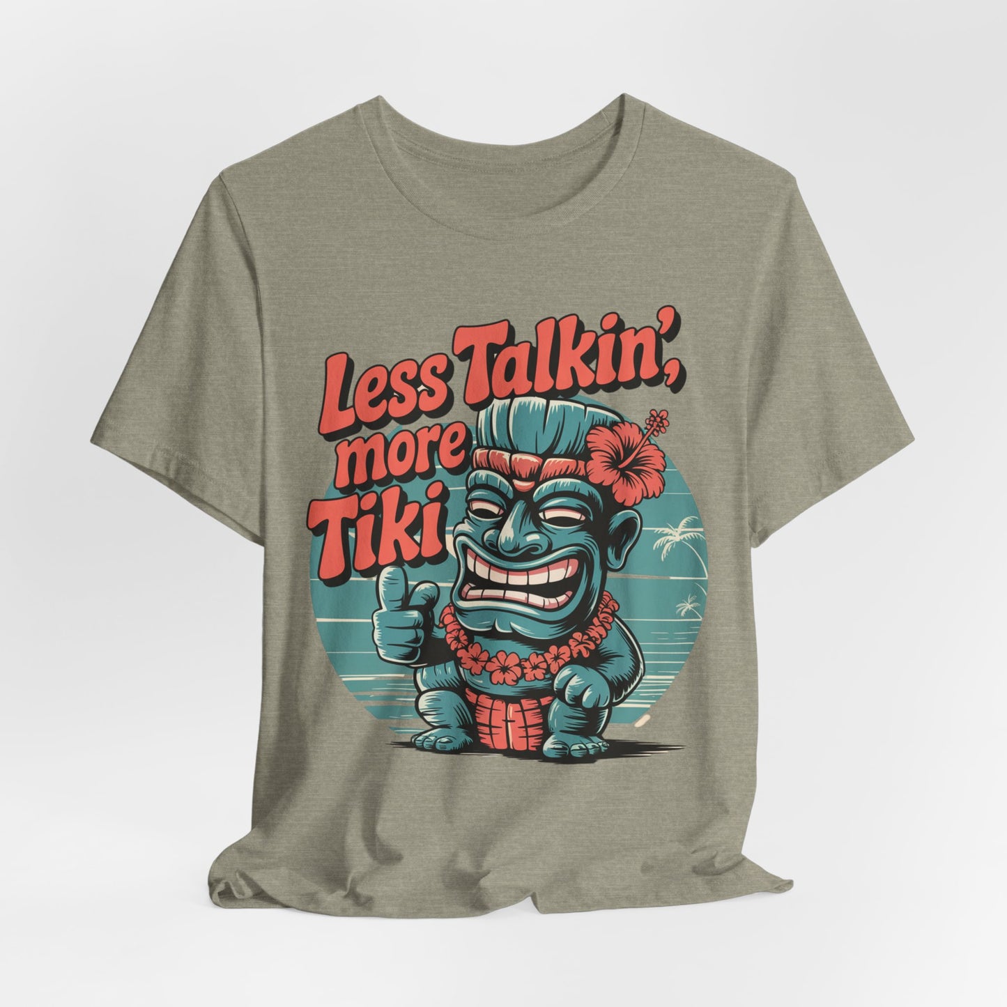 The Tiki Vibes Graphic Tiki T-Shirt is a green unisex shirt with a bold tiki statue, palm trees, and sunset, plus Less Talkin, More Tiki in vibrant red-orange text. Made from breathable fabric for comfort.