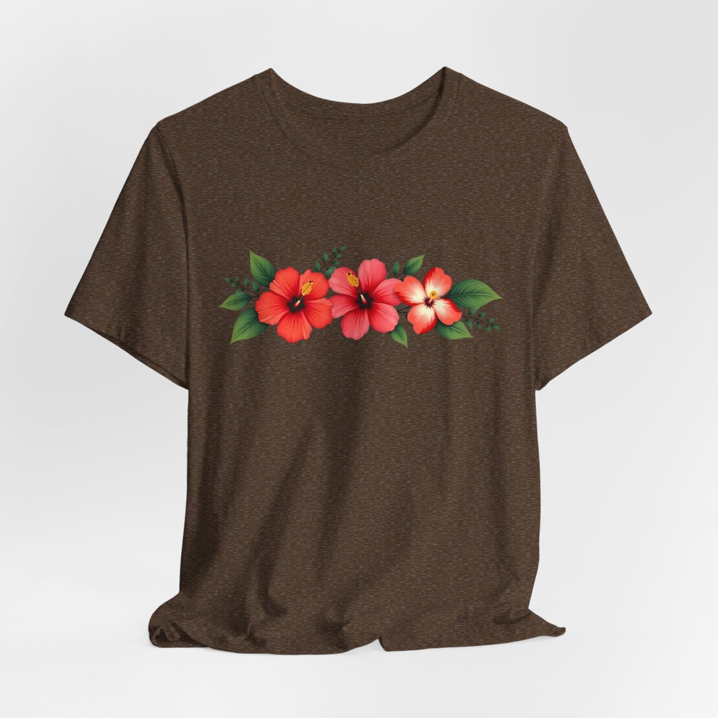 The Floral Unisex Short Sleeve T-Shirt - Perfect for Spring and Summer showcases three red and pink hibiscus flowers with green leaves on a brown 100% Airlume cotton tee, ideal for casual wear.