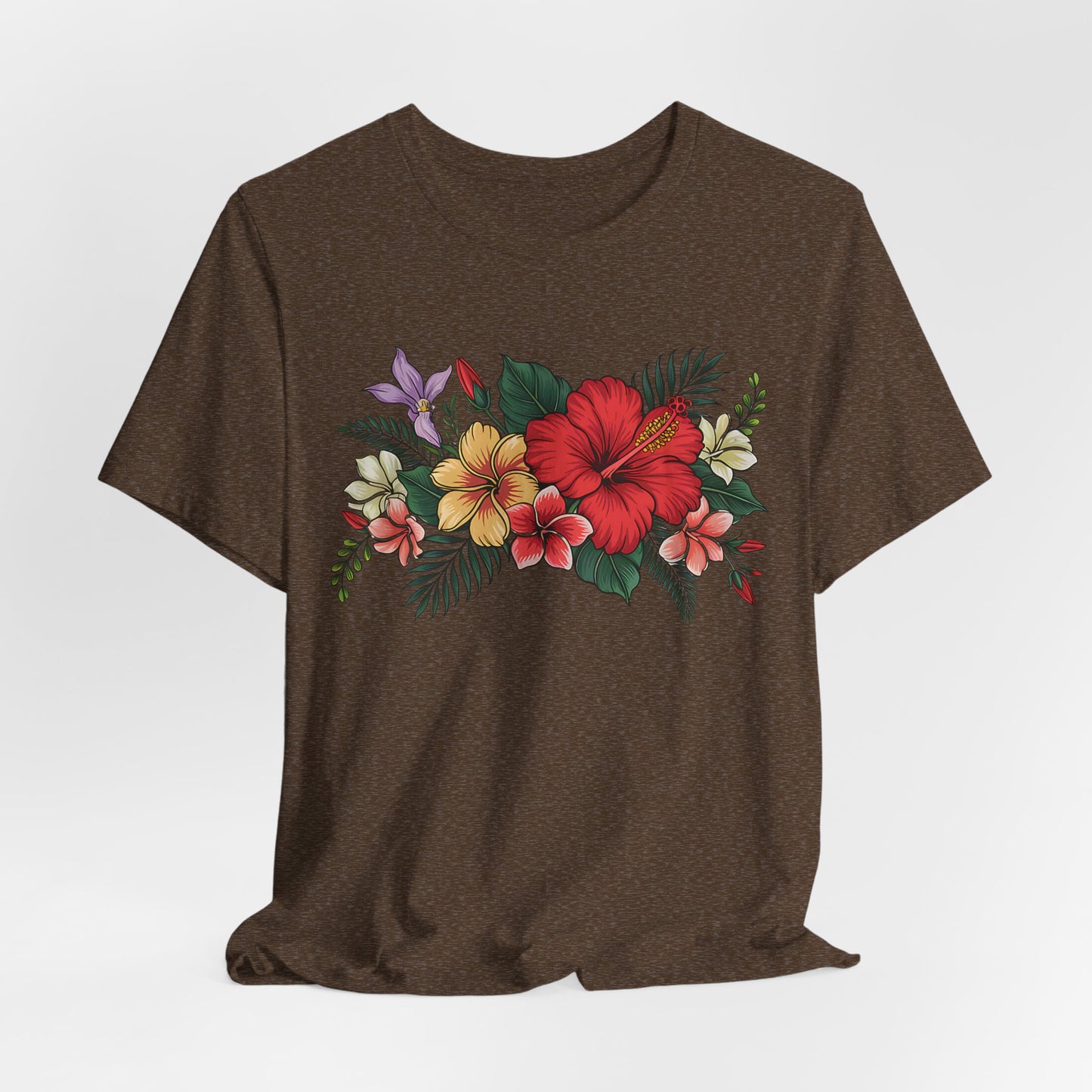 The Tropical Floral Unisex T-Shirt - Vibrant Summer Style showcases a dark brown base with red, yellow, and white hibiscus blooms and green leaves on the chest, made from soft Airlume cotton for comfort.