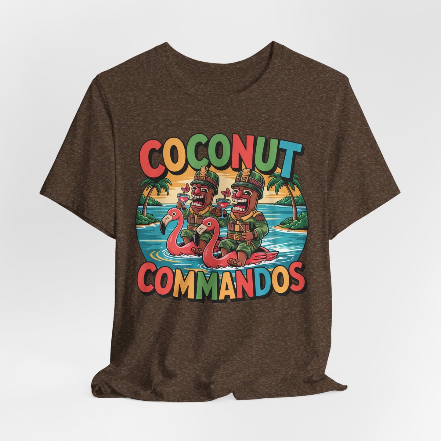 The Coconut Commandos Graphic Tiki T-Shirt features a colorful cartoon of two coconut characters on pink flamingo floats with palm trees, creating a fun, tropical summer vibe. Ideal for beach lovers. Text: Coconut Commandos.
