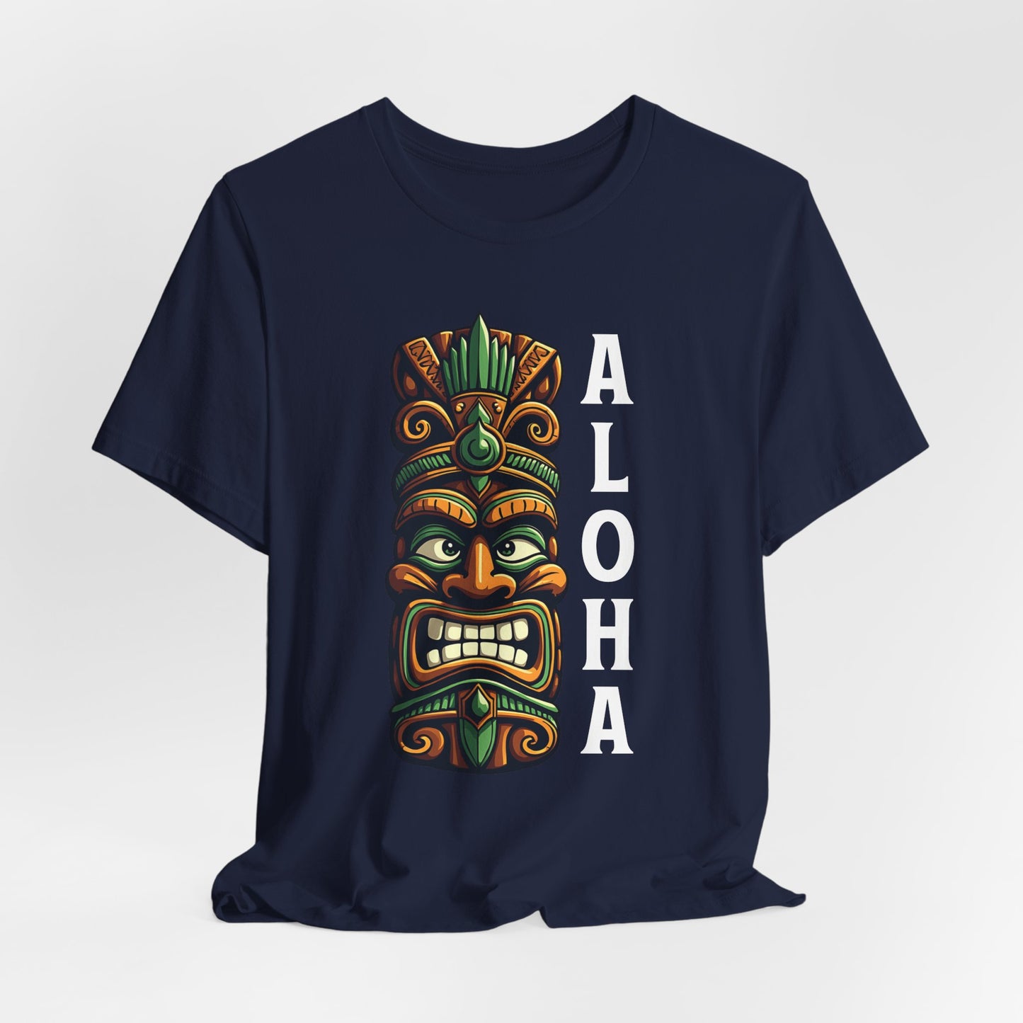The Aloha Tiki- Graphic Tiki T-Shirt for Beach Lovers is a navy blue unisex tee with a vibrant tiki mask and bold vertical “ALOHA”—an ideal pick for anyone wanting a tropical vibe.