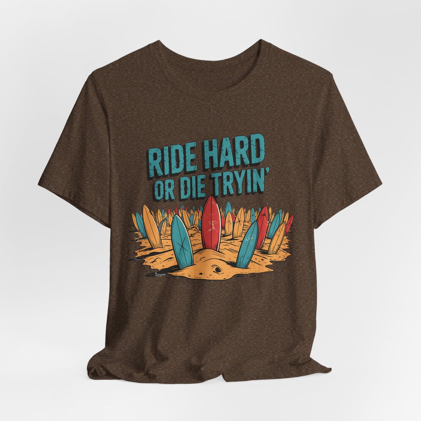 The Surfing T-Shirt - Ride Hard or Die Tryin Unisex Jersey features colorful surfboards in sand and bold text—a perfect pick for adventure seekers and surf lifestyle lovers.