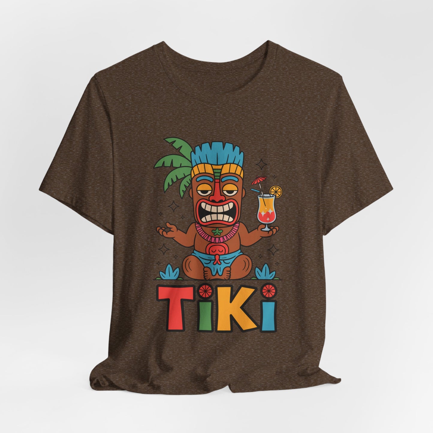 The Tiki Party Unisex Jersey Tiki T-Shirt - Tropical Vibe Graphic T-Shirt showcases a vibrant cartoon tiki with a blue headdress, tropical drink, and palm tree, plus TIKI text—all crafted with eco-conscious production for summer fun.