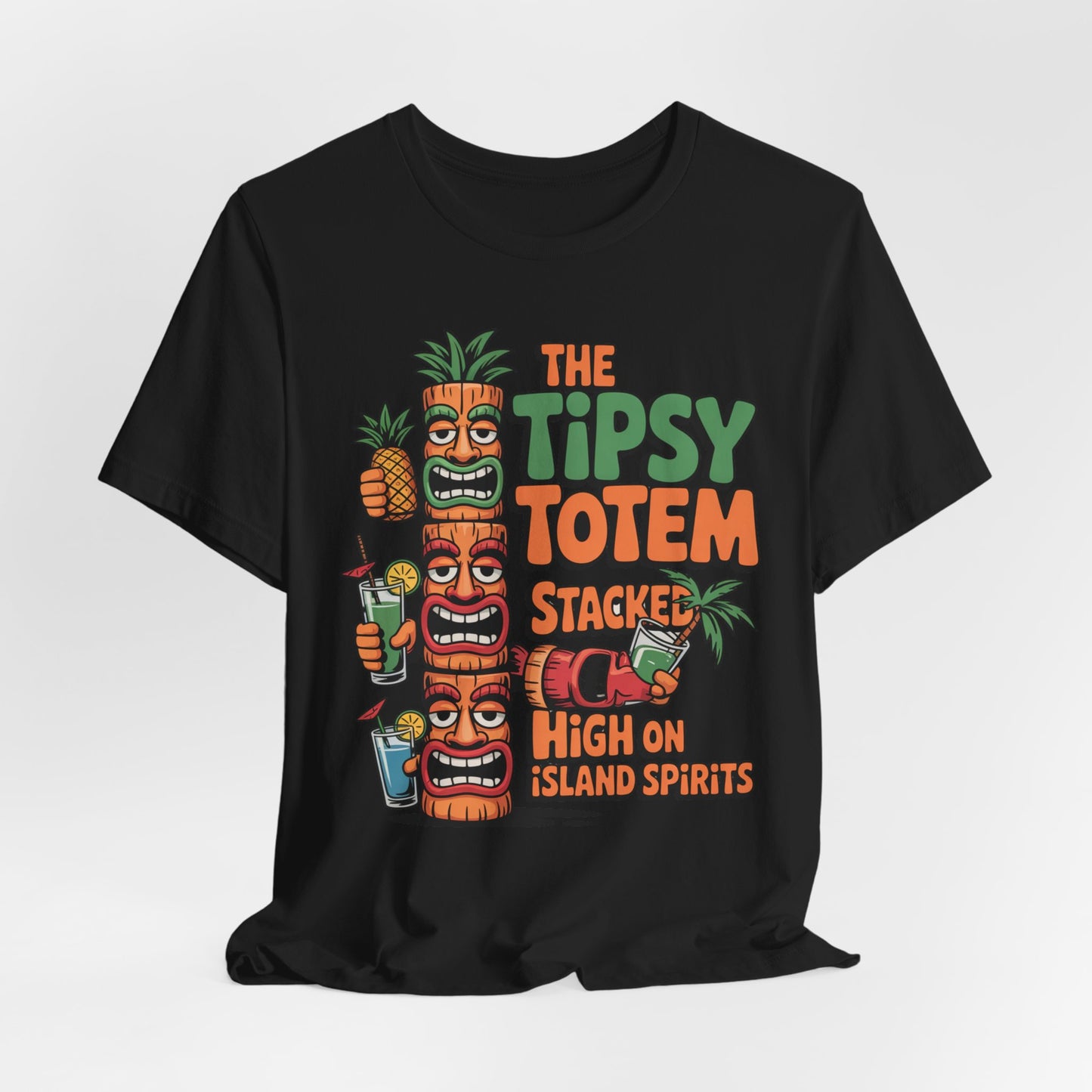 The Tiki Cocktail Tee - The Tipsy Totem Graphic Shirt features colorful text and illustrations of three tiki totems, tropical drinks, a pineapple, and palm leaves—perfect for bringing a tropical vibe to summer parties.