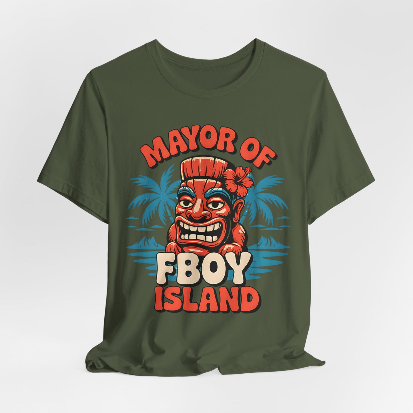 The Mayor of FBOY Island Short Sleeve Tiki T-Shirt is a green, 100% Airlume cotton tee featuring a cartoon tiki head, playful spirits, palm trees, and MAYOR OF FBOY ISLAND text in red and beige for fun summer vibes.