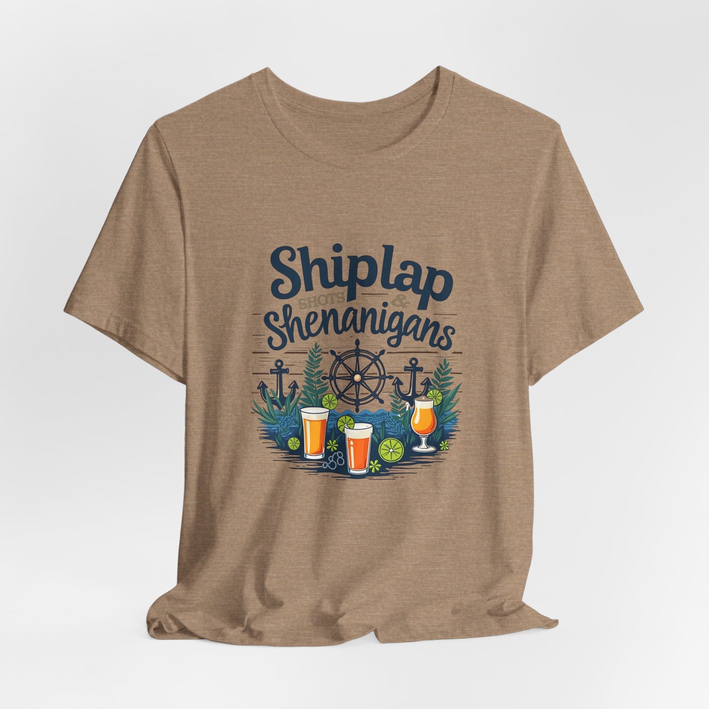 The Shiplap Shenanigans Unisex Short Sleeve Tee—ideal for brewery lovers—features Shiplap Shenanigans above nautical icons, plants, and vibrant drinks on tan Airlume combed and ring-spun cotton for relaxed comfort.