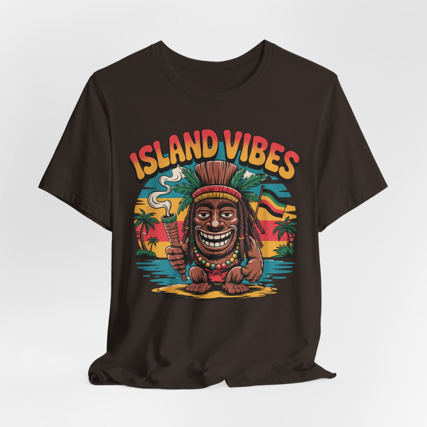 The Island Vibes Unisex Jersey Tiki T-Shirt features a vibrant cartoon tiki sipping a drink and smoking by the ocean at sunset, palm trees in the background, and bold “ISLAND VIBES” text—perfect for vacations and summer fun.