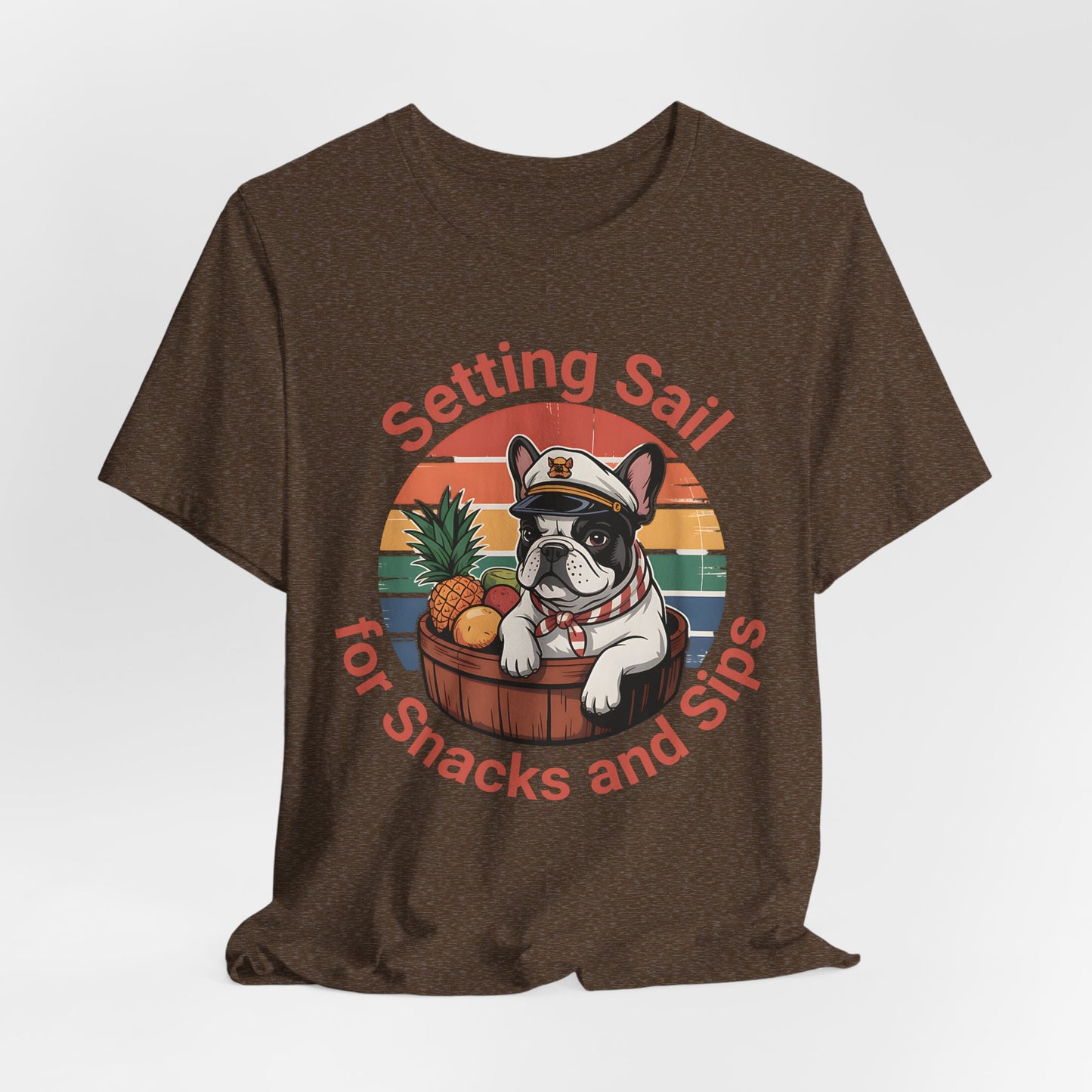 Great for dog lovers and beach fans, the Setting Sail for Snacks and Sips T-Shirt is a fun unisex jersey tee featuring a French bulldog dressed as a sailor in a fruit barrel with the text: “Setting Sail for Snacks and Sips.”.